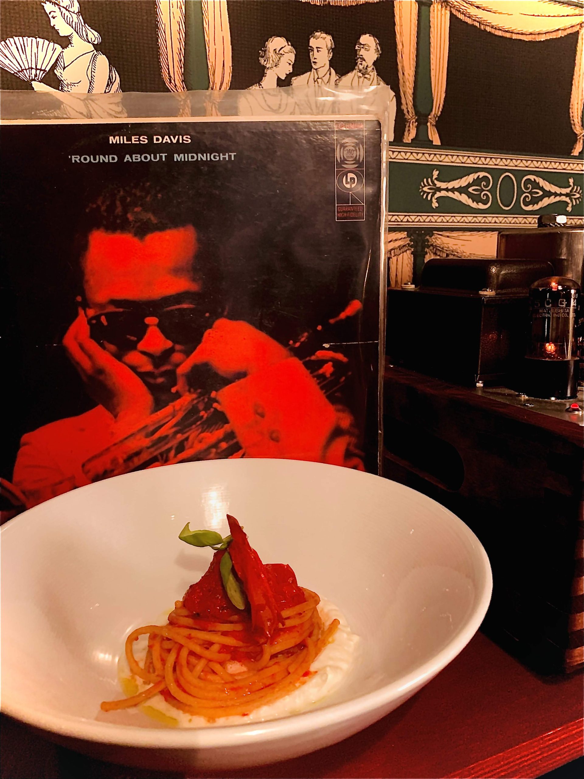 Spaghetti dish and a Miles Davis vinyl record at Barcola Bistro restaurant, Montreal