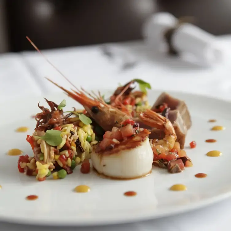 A dish of scallops and prawns at La Chronique, one of the most romantic restaurants in Montreal for proposals and anniversaries