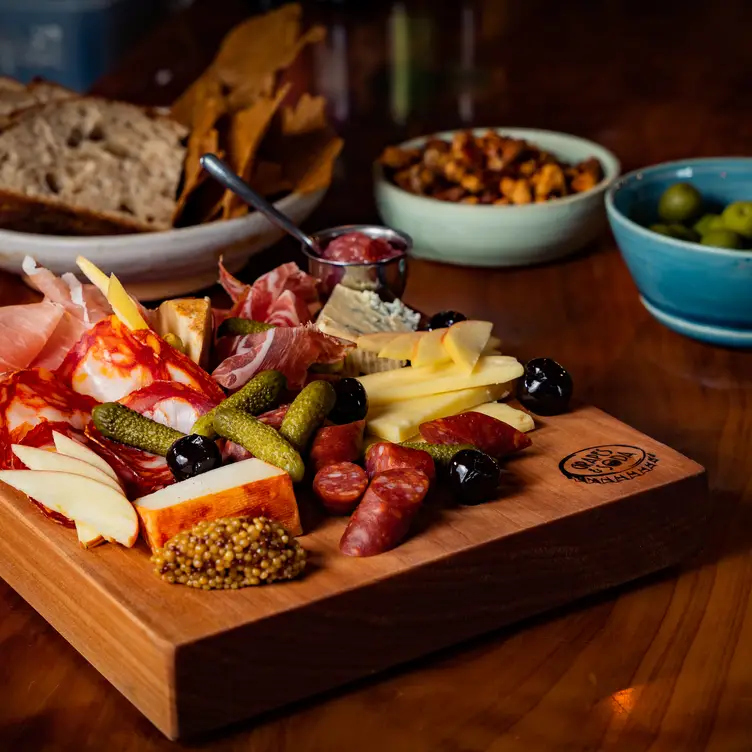 A board of cheese and charcuterie with nuts, crackers and bread at Share a board of cheese and charcuterie with nuts, crackers and brea, one of the best date restaurants in Vancouver