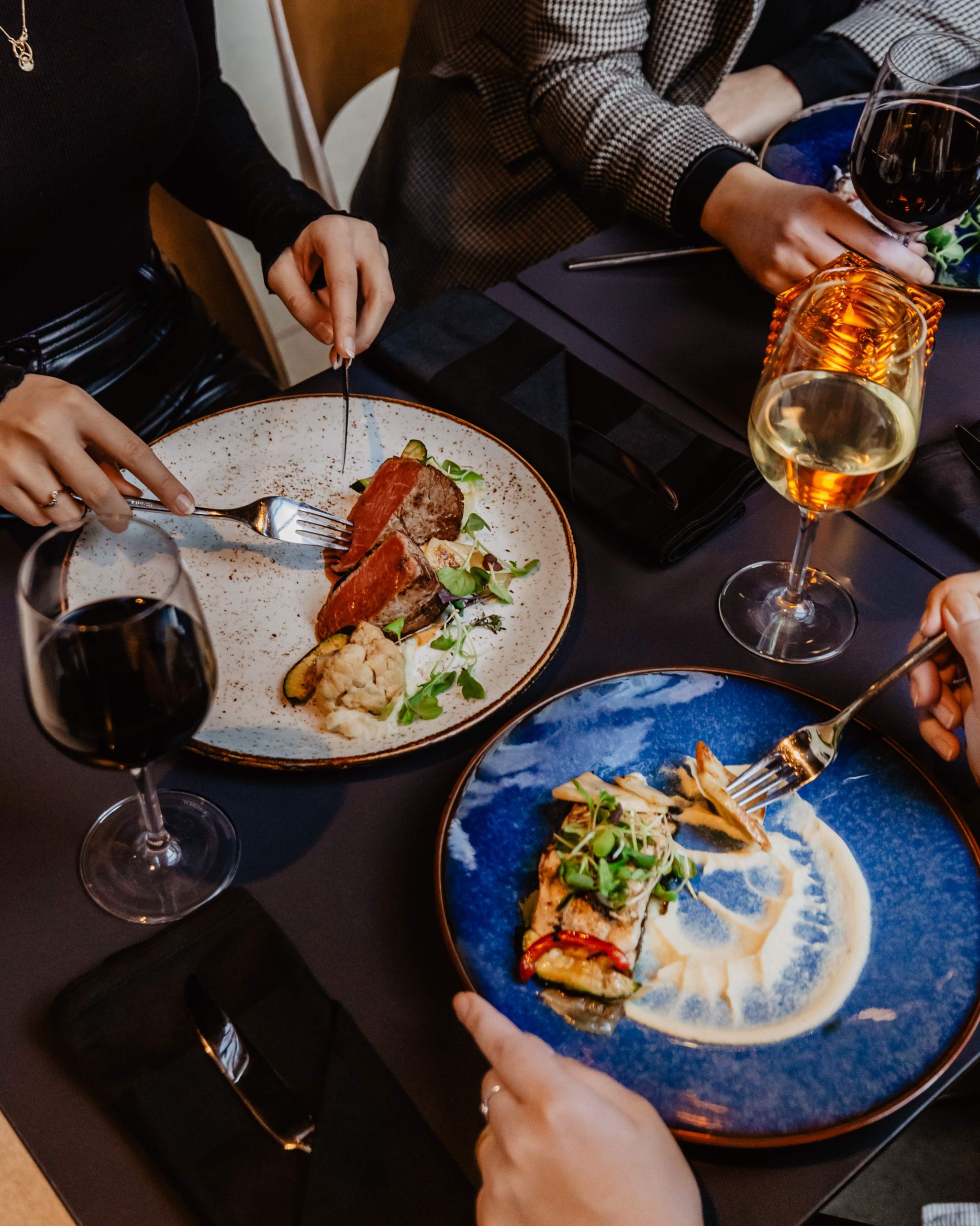 Two people eating and drinking at a restaurant