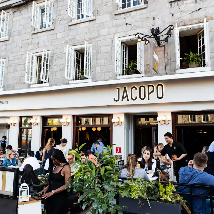 The outdoor terrace with diner eating out at Jacopo, an Italian restaurant in Montreal