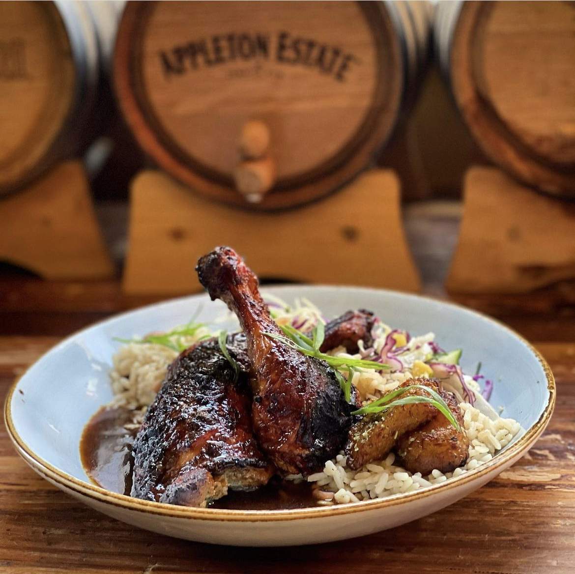 Jerk chicken with rice and peas, ripe plantains and coleslaw at Calabash Bistro, a restaurant in Toronto