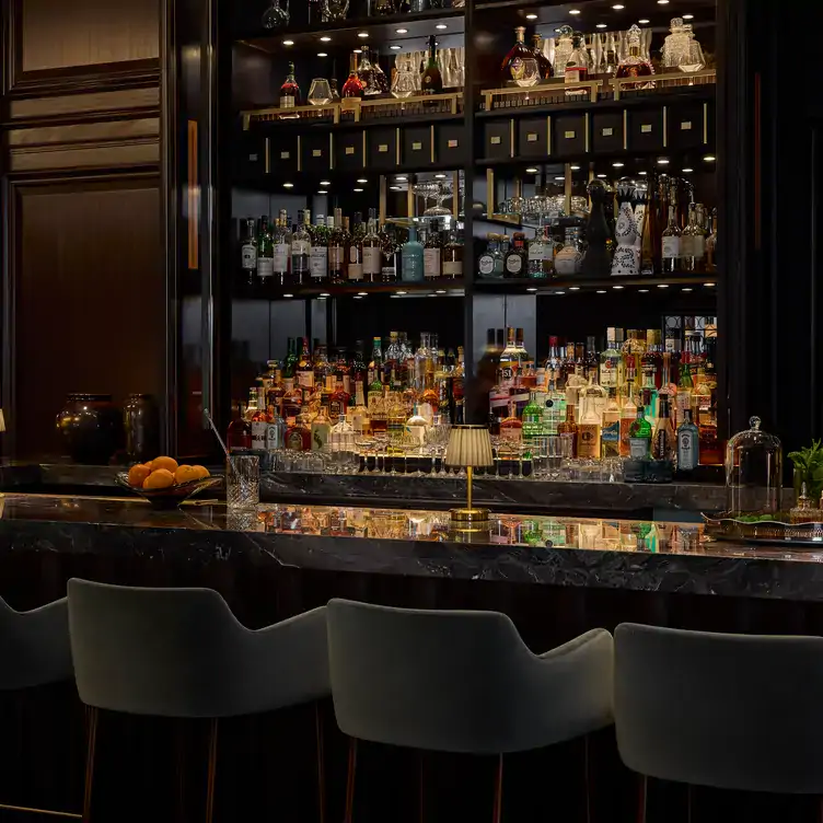 A bar shelf with different alcohols in a subdued light from The Georgia Bar.