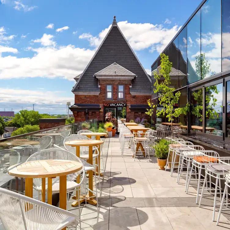 The sunny rooftop terrace at Rooftop Bar at the Broadview Hotel, one of the best rooftop patios in Toronto