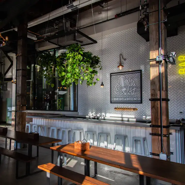 The white outdoor bar at Steam Whistle Kitchen, one of the best beer gardens in Toronto