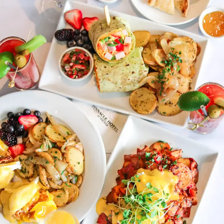 A spread of brunch dishes and bloody marys at The Lobby - Pinnacle Hotel at the Pier