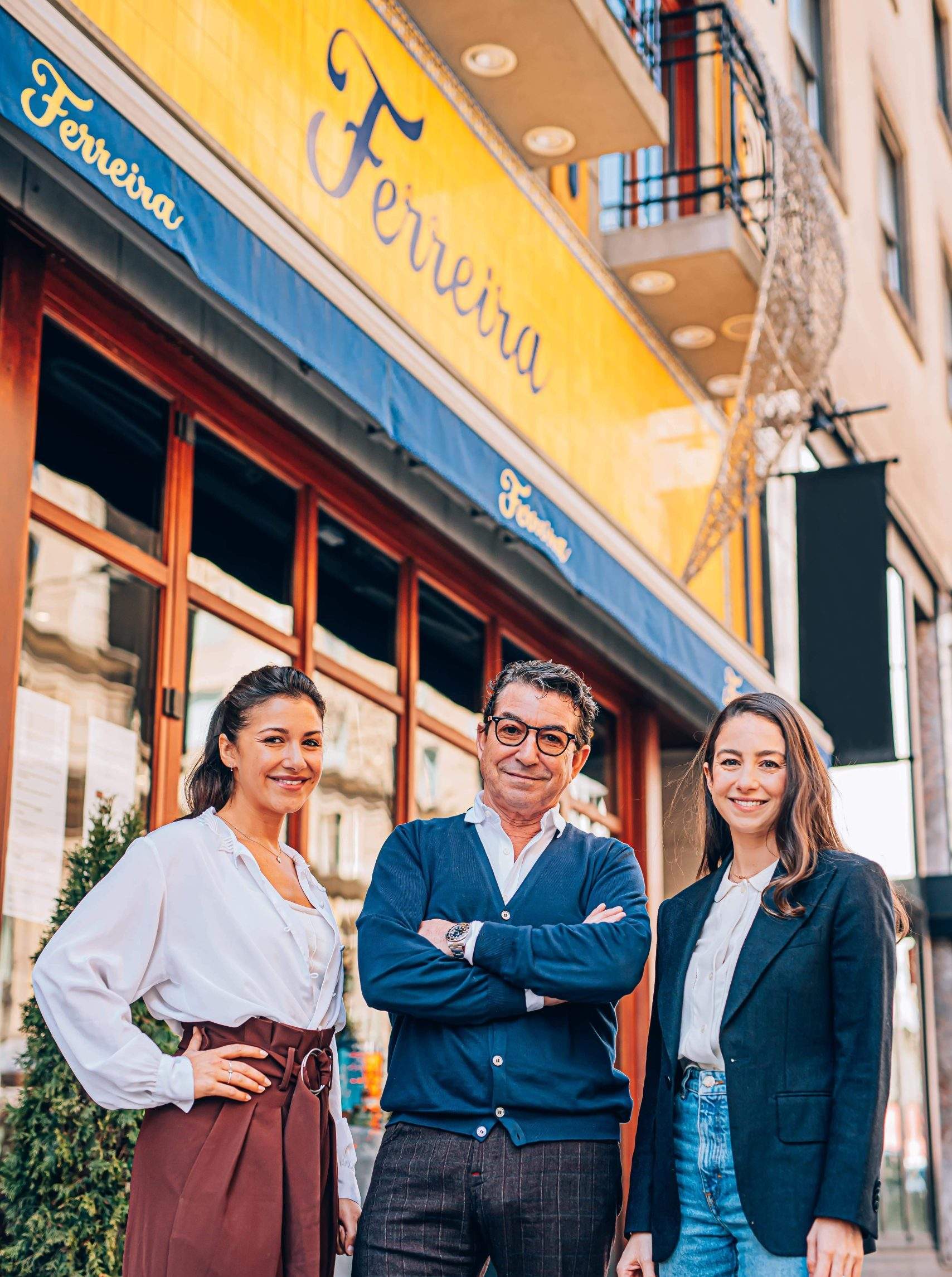 Ferreira Café owners Claudia, Carlos, and Sandra Ferreira (from left to right) standing in front of their restaurant in Montreal.