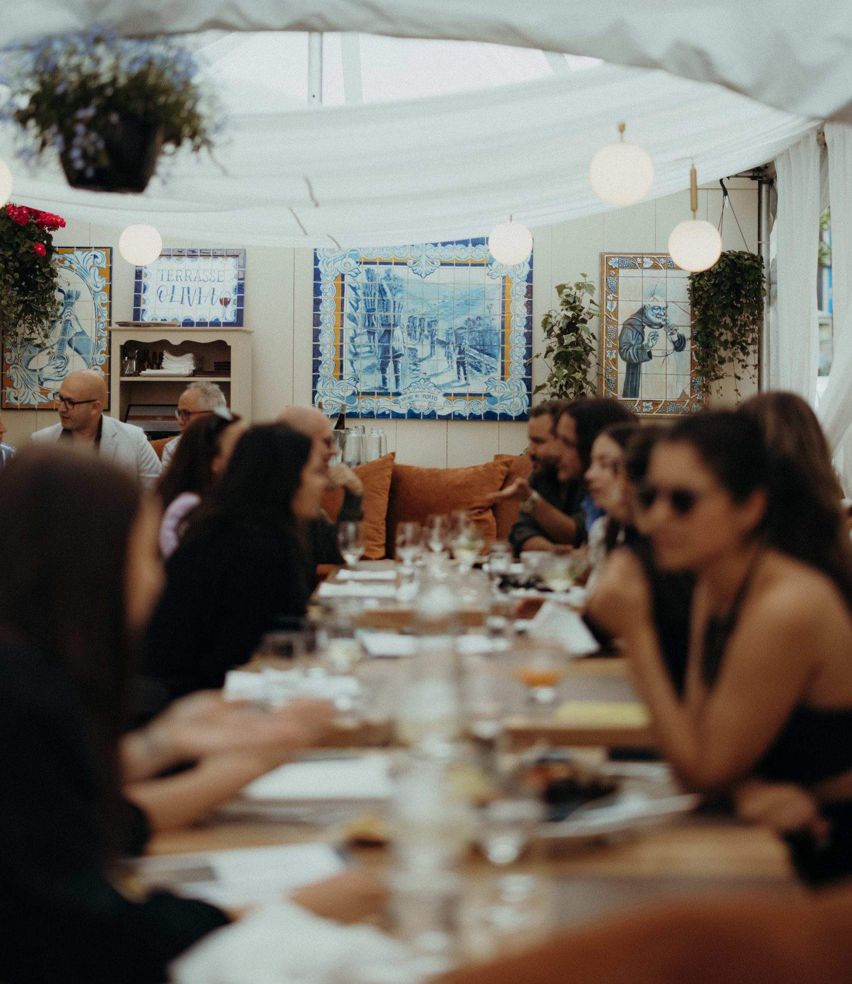 A long table with diners seated on both sides at Montreal restaurant Ferreira Café.