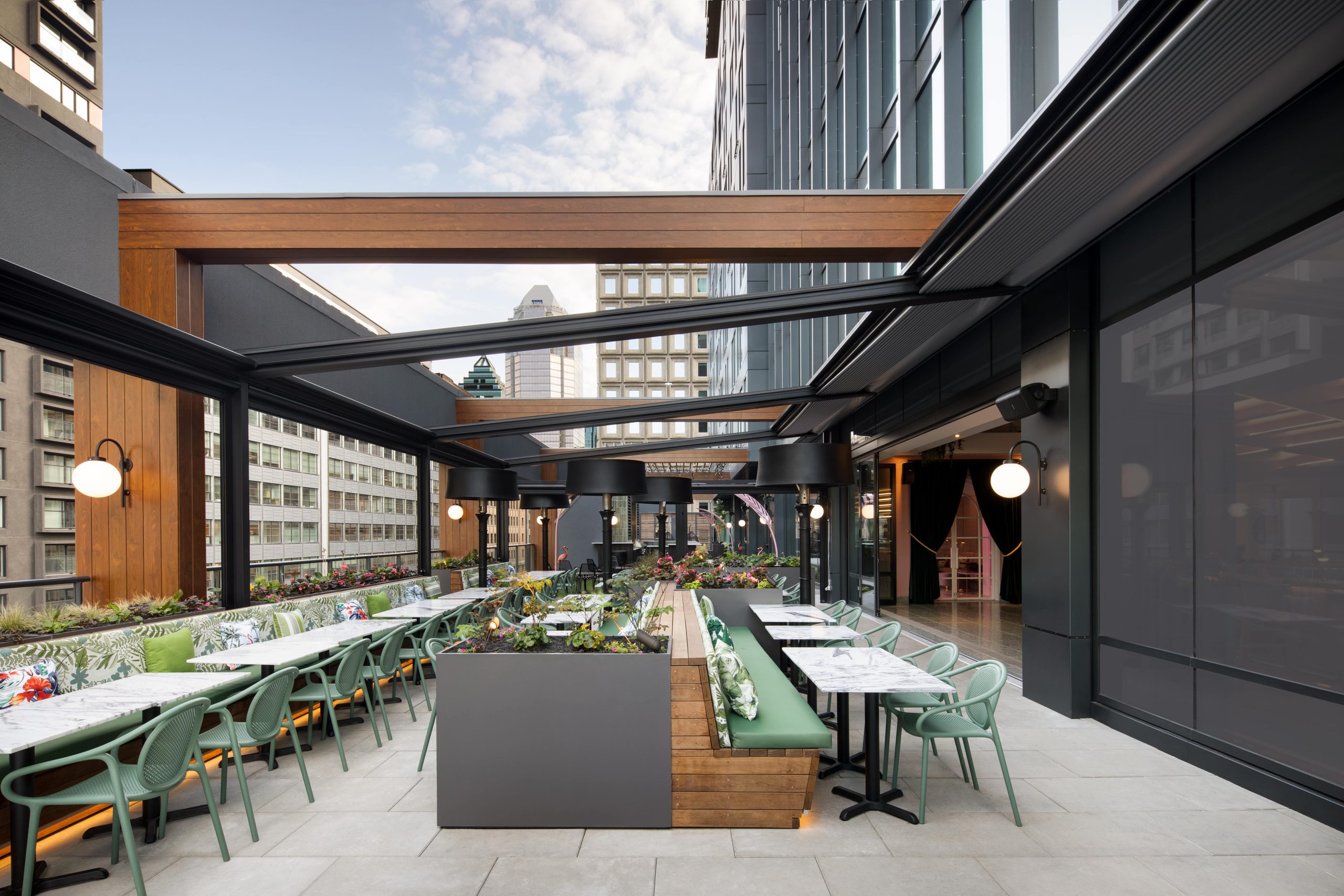 Rows of tables and chairs on a fifth-floor terrace at Muze Lounge & Terrasse, one of the best new restaurants in Montreal for 2023.