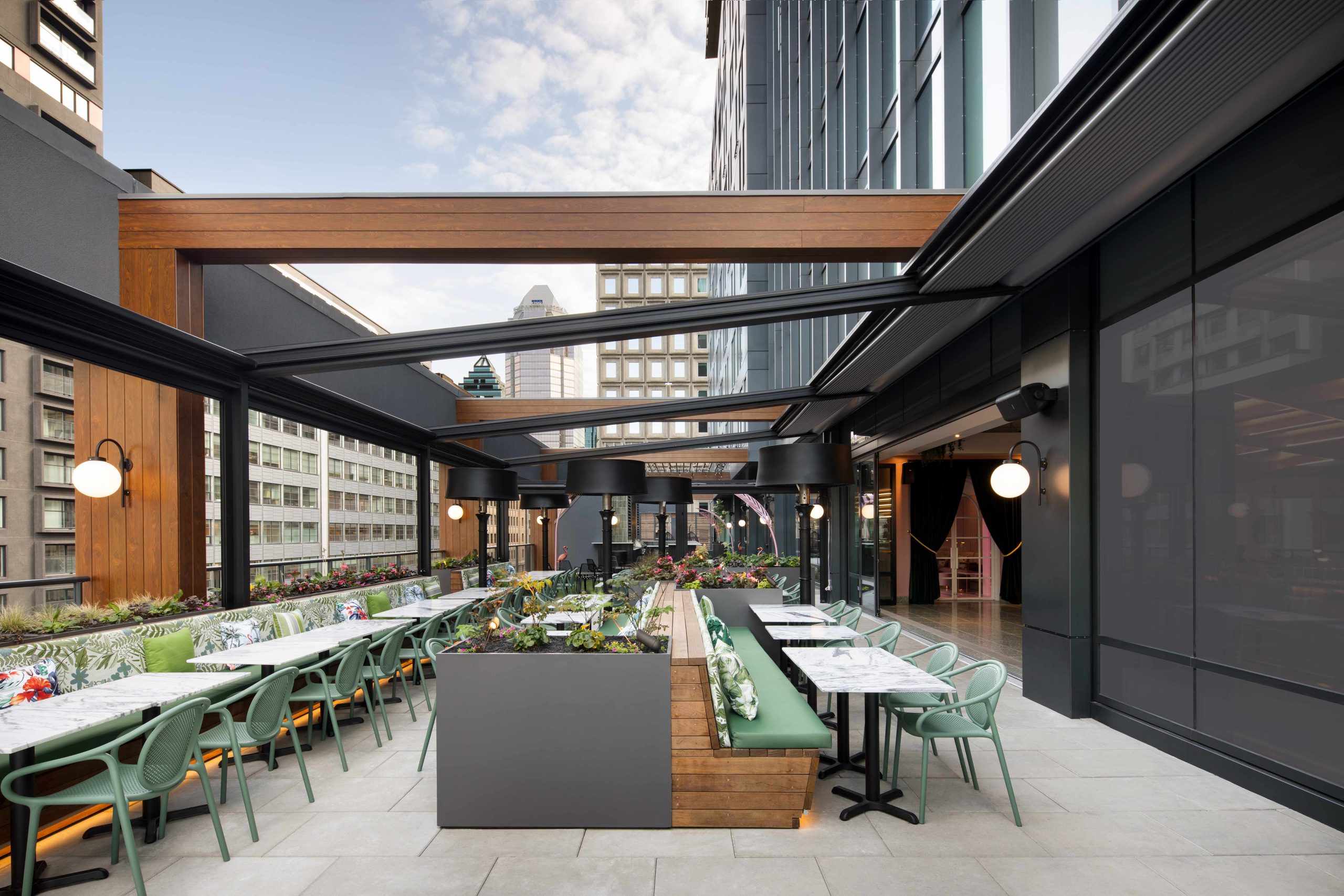 Des rangées de tables et de chaises sur la terrasse au cinquième étage du Muze Lounge & Terrasse,un des meilleurs nouveaux restaurants de 2023 à Montréal.