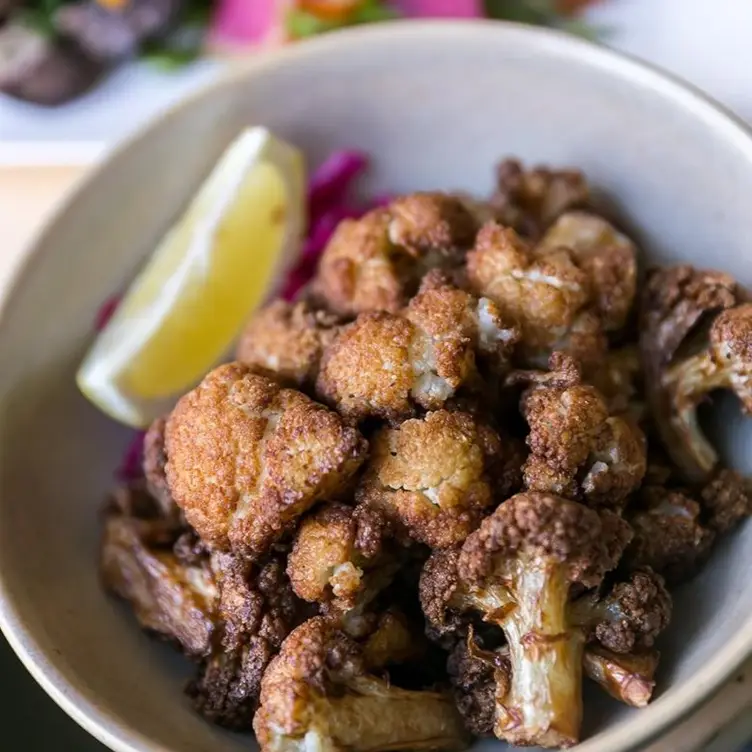 Najib’s Special is a must-try for vegetarians, featuring crispy and citrusy cauliflower bite, at Nuba, one of the best vegetarian-friendly restaurants in Vancouver.