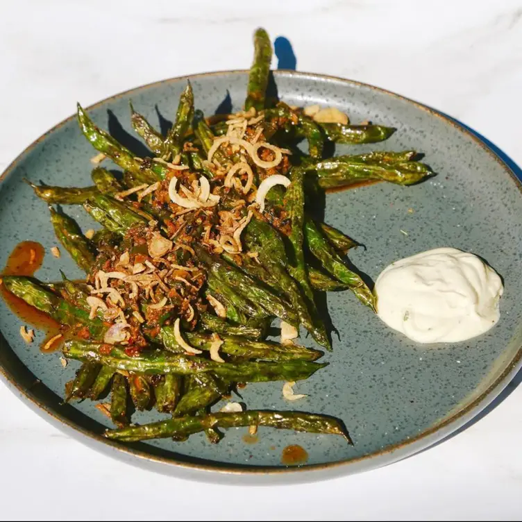 Among the most popular shareables for the table are the green bean, ginger scallion oil, chili, and crispy shallots at Zarak by Afghan Kitchen.