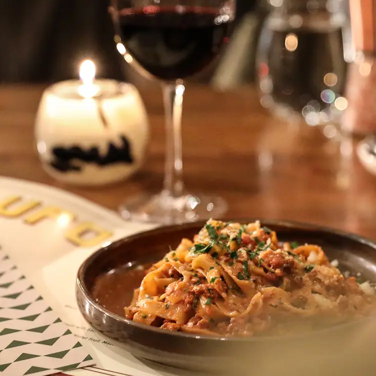 Tomato pasta on a plate with herbs at LUPO Italian Ristorante and Patio, the best contemporary Italian in Banff.