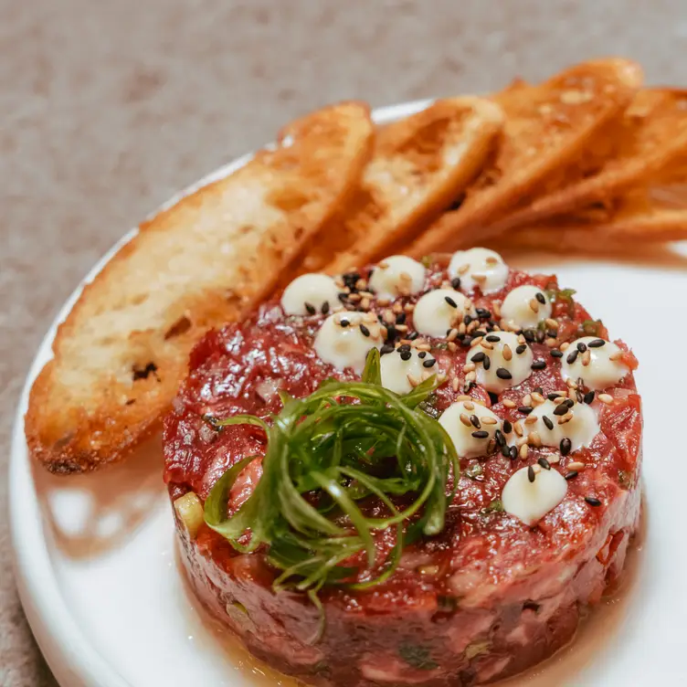 Steak tartare with koji browned butter emulsion, served with crostini at Yokai Izakaya, among the best ethnic restaurants in Toronto.