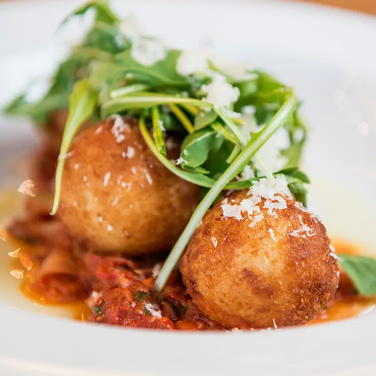 Saffron and ricotta infuse prosciutto in crispy arancini risotto balls at Bonaterra Trattoria, in Calgary.