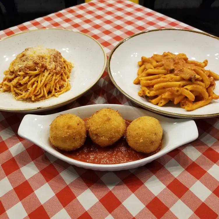 Enjoy some arancini full of gooey warm mozzarella, pomodoro sauce, and umami pamigiano. Credit: Trattoria Taverniti