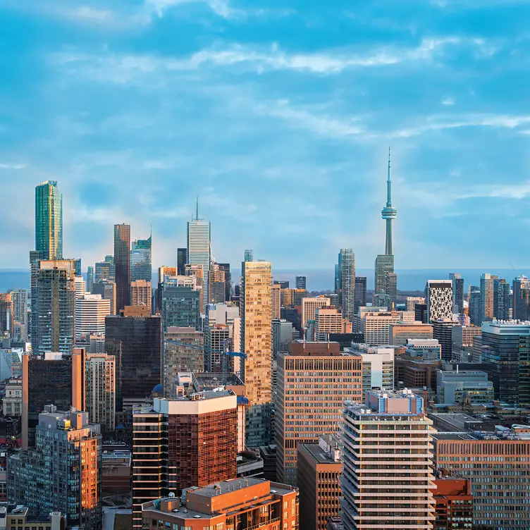 The view of Toronto featuring the CN tower and Lake Ontario, from AP, one of the best Asian restaurants in Toronto.