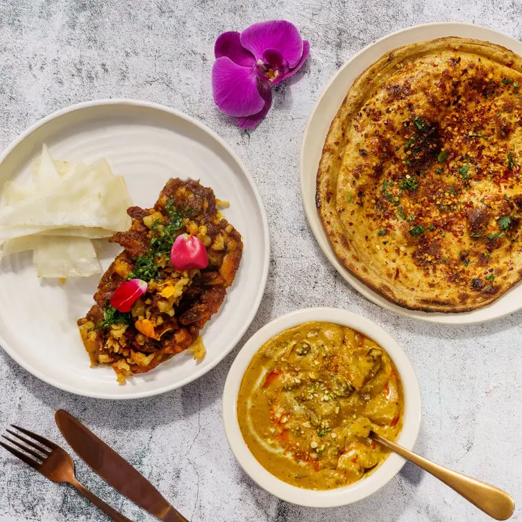 An array of delectable dishes on the table at Clove - The Art of Dining, one of Vancouver’s best Indian restaurants.