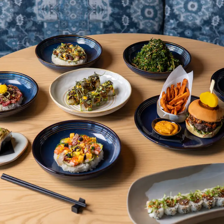 Plates including sushi and seaweed salad at AP in Yorkville, one of the best Asian restaurants in Toronto.