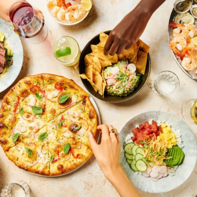 People sharing food at Earls Kitchen + Bar, one of Toronto’s best vegan restaurants.