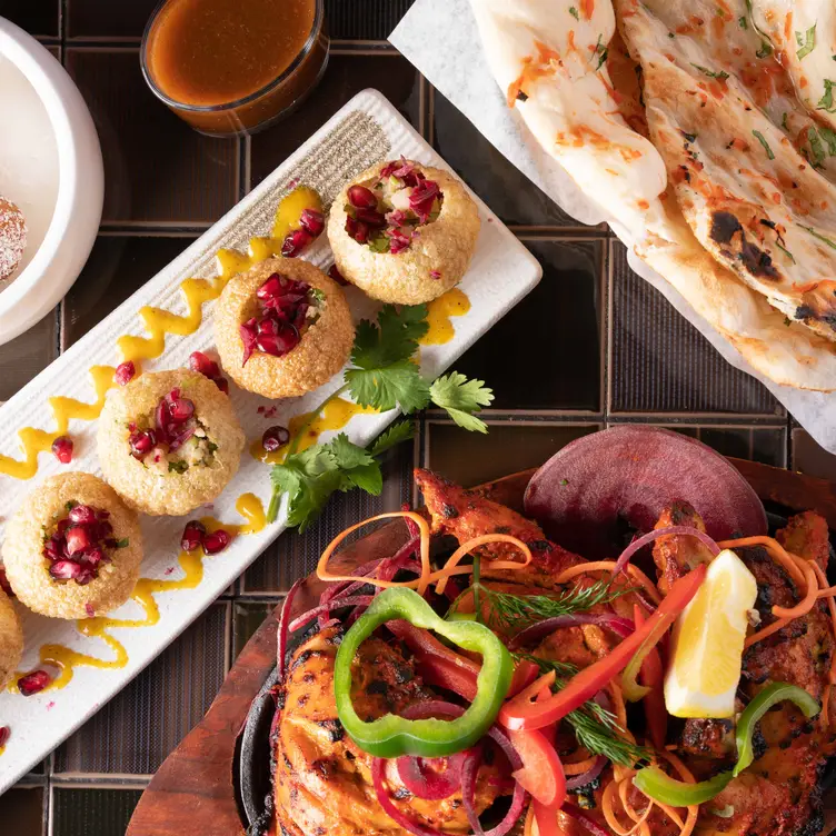 Traditional dishes are laid out on the table at Hariyali Express Indian Cuisine & Bar, one of the best Indian restaurants in Vancouver.