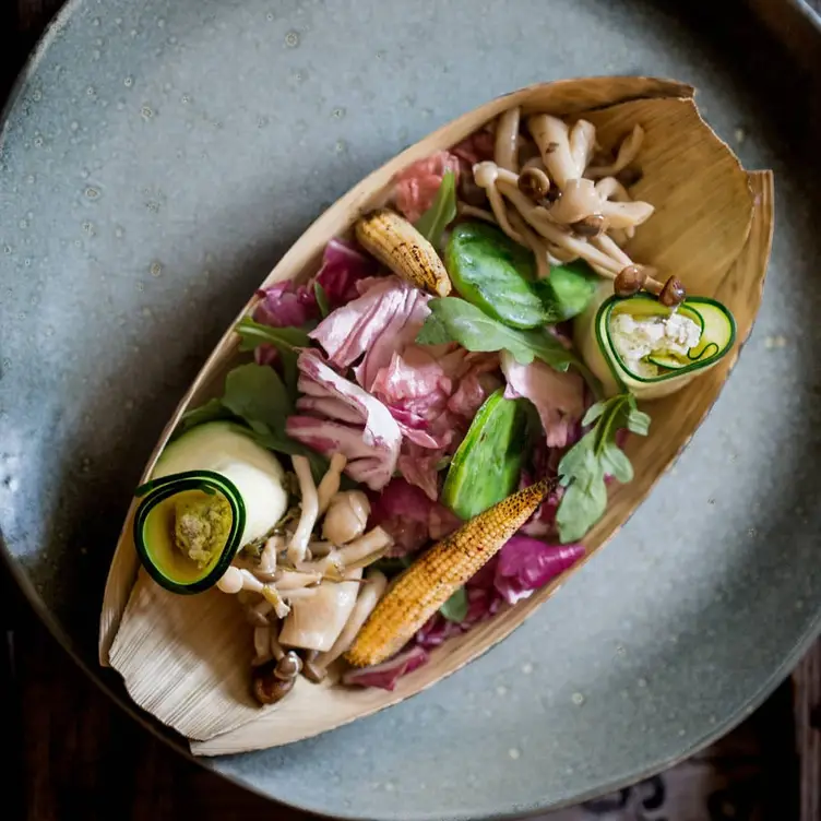 An avocado leaf with corn and mushrooms at La Bartola, one of the best vegan restaurants in Toronto. Credit: La Bartola