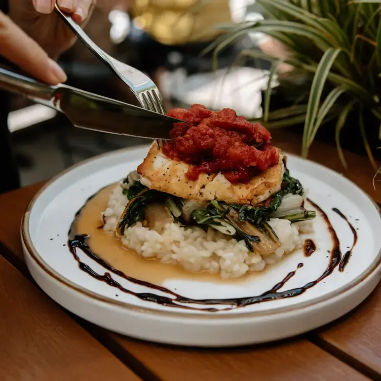 The delicately presented Seasonal Halibut and Risotto at one of the best seafood restaurants in Vancouver.