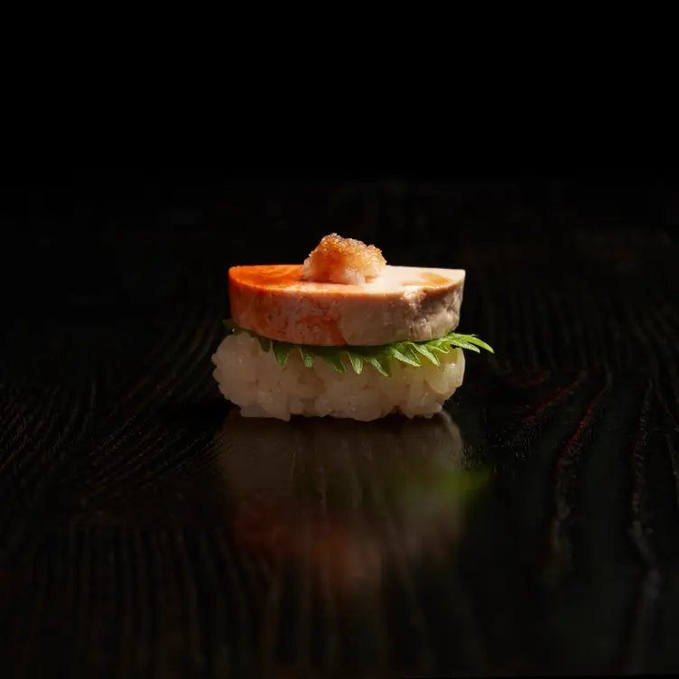 A seafood patty rests on a dial of rice at Yasu, possibly the best Japanese restaurant in Toronto.