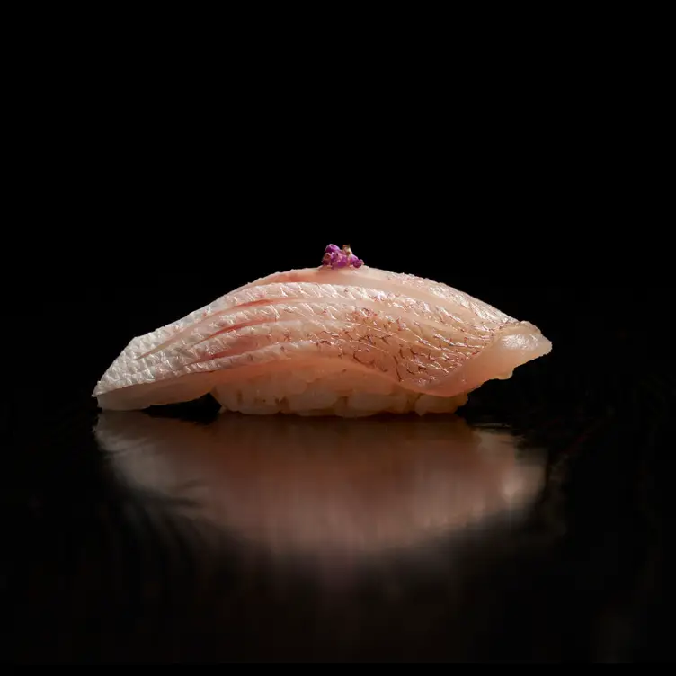 Pink seasonal sashimi on rice at Yasu, one of the best sushi restaurants in Toronto.