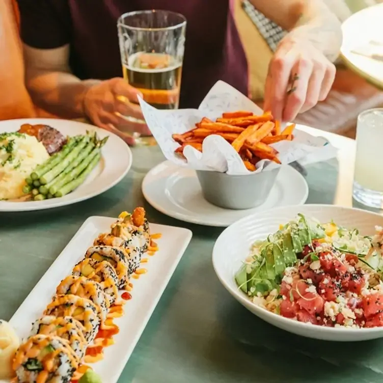 Sushi, sweet potato fries, and a poke bowl at Earls Kitchen + Bar.