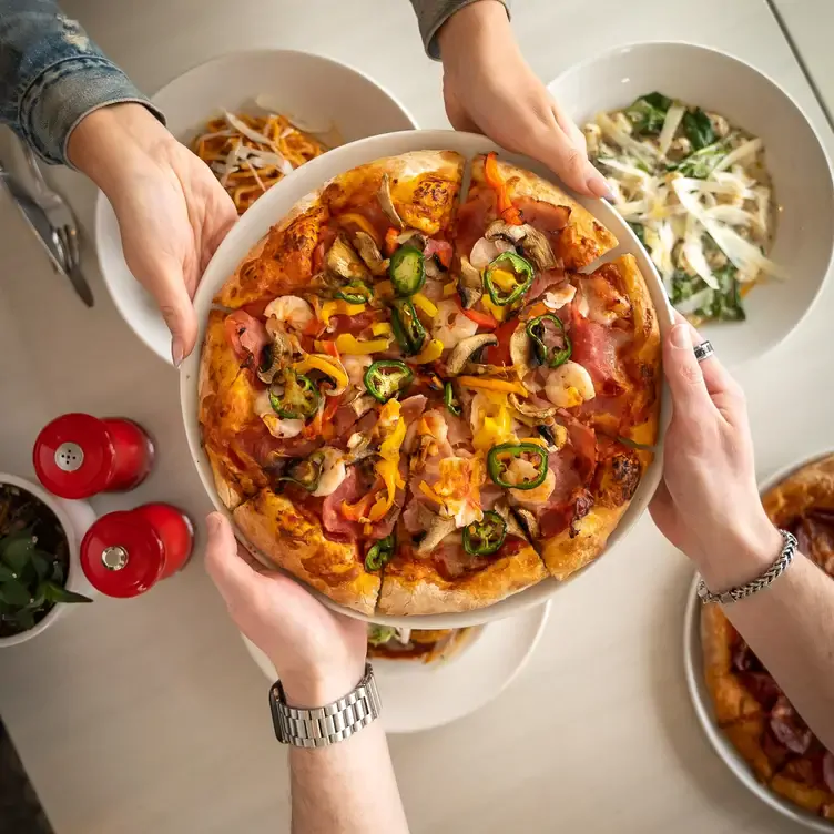 Pizza topped with ham, jalapenos, and mushrooms at PZA Parlour