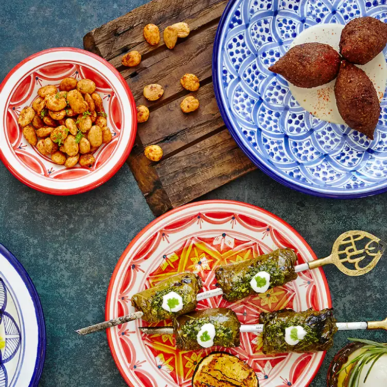 Falafel, fries, and skewers on a table at Byblos Uptown, of the best restaurants in Toronto for Valentine’s Day.