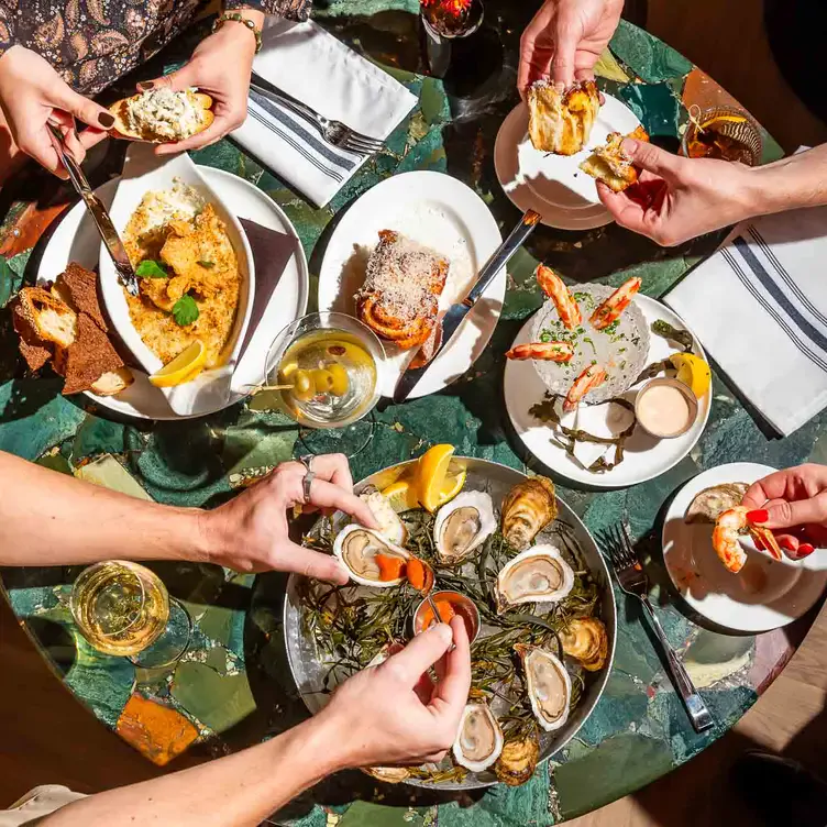 Oysters and shrimp on a table with wine at The Joneses, one of Toronto’s best new restaurants.