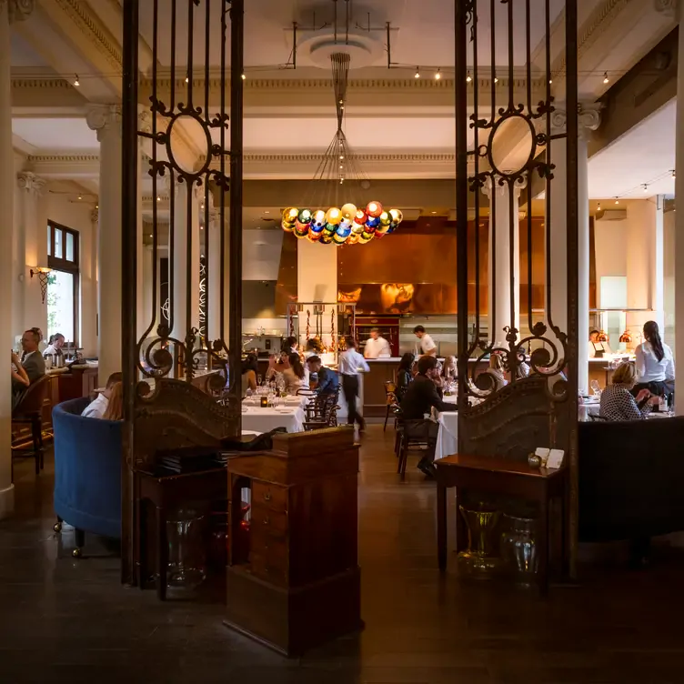 The welcoming dining room features an open kitchen at Teatro Restaurant, one of the best romantic restaurants in Calgary.