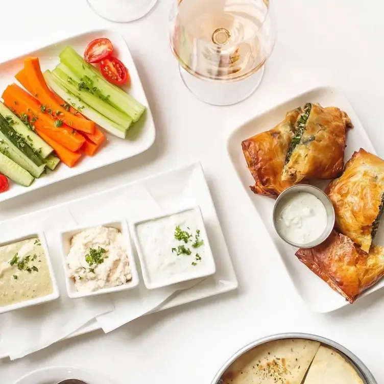 Homemade dips and veggie sticks with spanakopita spinach and feta pastry at The Greek - Broadway, one of Vancouver’s best new restaurants 2024.