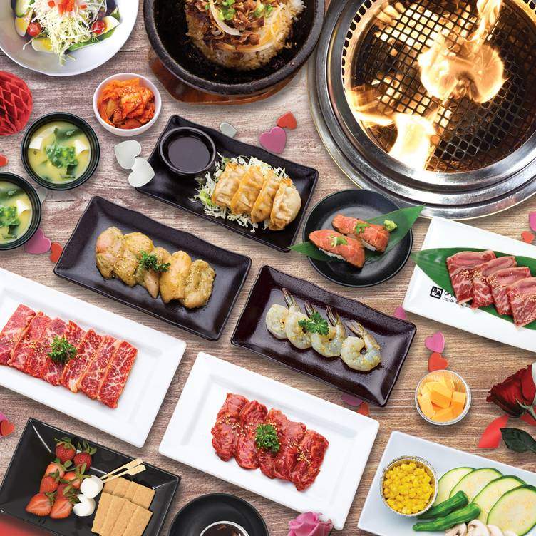 Marinated beef with plentiful sides at Gyu-Kaku, the best family restaurant in Calgary with in-table grills.