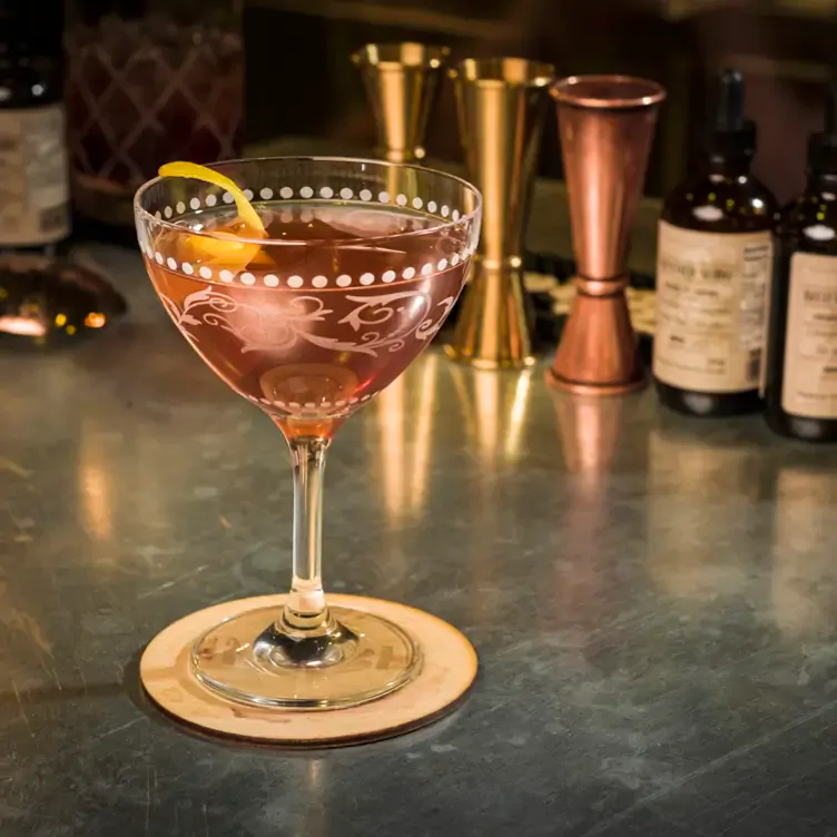 A pink cocktail on the bar at The Nash, possibly the best date night restaurant Calgary offers.