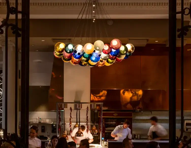 The open kitchen in the main dining room at Teatro Restaurant, one of the best date night restaurants Calgary offers.