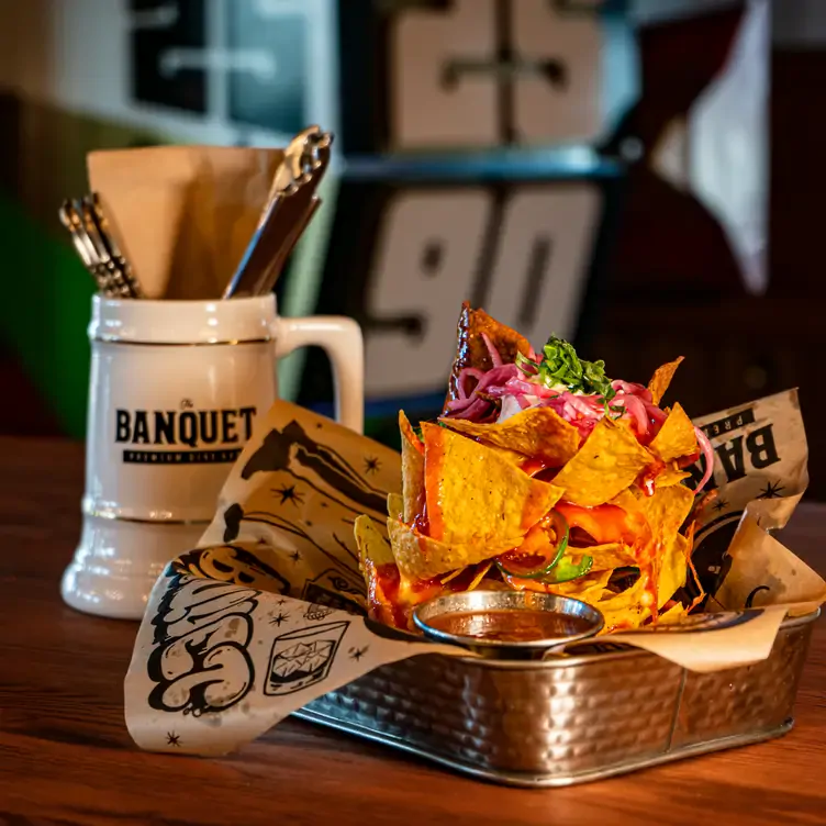 Loaded tortilla chips with cheese and jalapenos at The Banquet, one of the best family-friendly restaurant Calgary has.