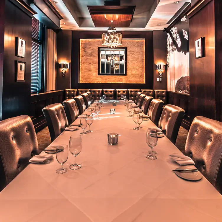 A private dining room and leather chairs at Vintage Chophouse & Tavern, one the best date night restaurants in Calgary.