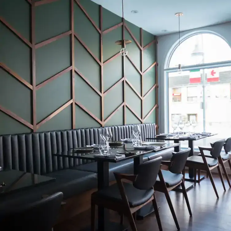 A bright restaurant room with several tables next to a large window from Mati, one of the best brunches in Ottawa.