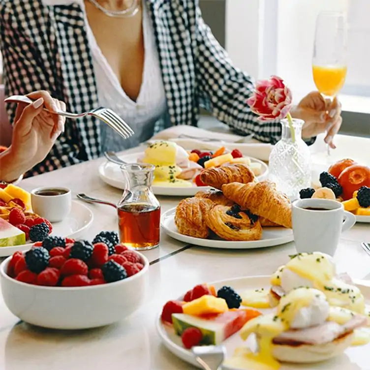 A brunch spread featuring fruits, pastries and eggs at Arôme, one of the best brunch restaurants in Ottawa.