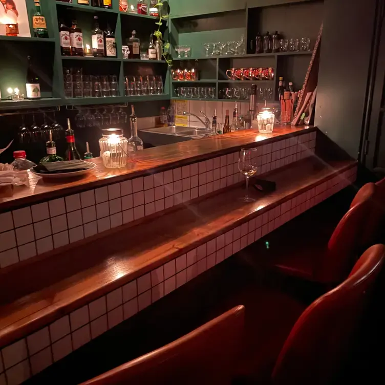 The warm colors and candlelight make up the ambience in Season Six’s bar area. Credit: Season Six