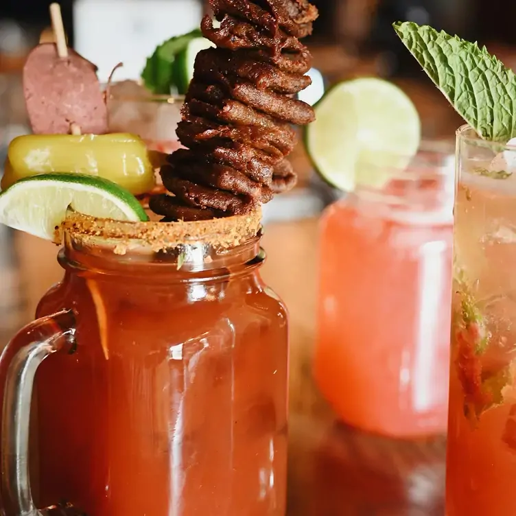 An in-house Caesar creation with a stick of meat at Blowers & Grafton, one of the best brunch spots Calgary offers.