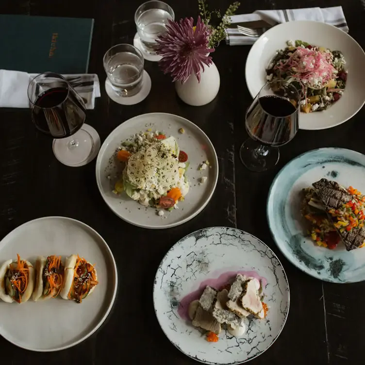 An array of beautifully plated dishes paired with glasses of red wine over at one of the best ambience restaurants in the Toronto area.