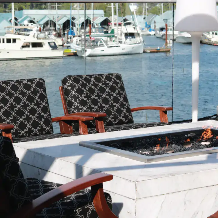 Comfortable patio seating by the Marina at LIFT Bar Grill View, one of the best view restaurants in Vancouver with a rooftop patio.