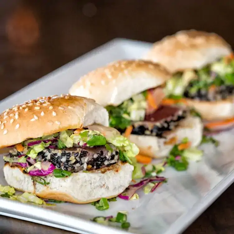 Three burgers at Union Social Eatery, one of the best rooftop restaurants in Toronto.