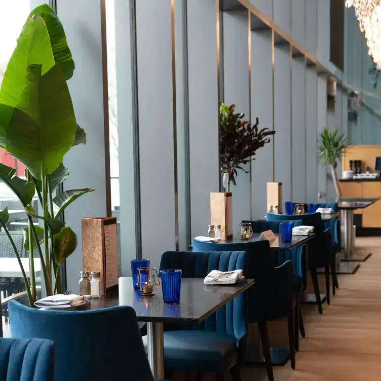 Tables sit under soaring windows at Irene, one of the best restaurants in the Harbourfront district of Toronto.