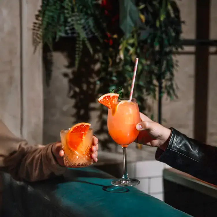 Two orange cocktails at Baro, one of the top rooftop restaurants in Toronto.