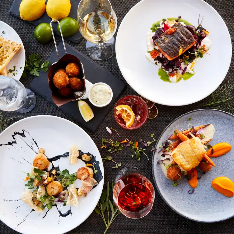 A selection of seafood with white wine and fruit cocktails at Dockside Restaurant, one of the best view restaurants Vancouver has.